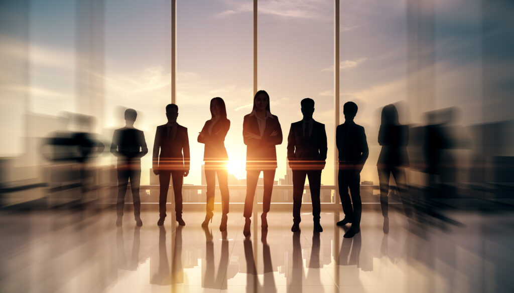businesspeople standing as team office with sunlight shining through windows creating silhouettes motion blur effects