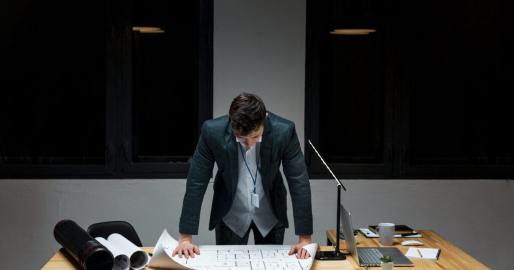 Key challenges and barriers that hinders SMEs to go Public 22 front view young male tired working night scaled e1788945125487