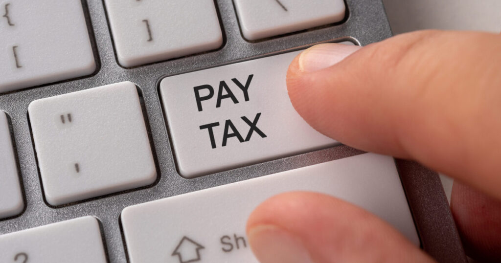 Settle Your Tax Installment Payment Before 15 January 2023 23 male hand pressing keyboard button pay tax scaled e1788941196951