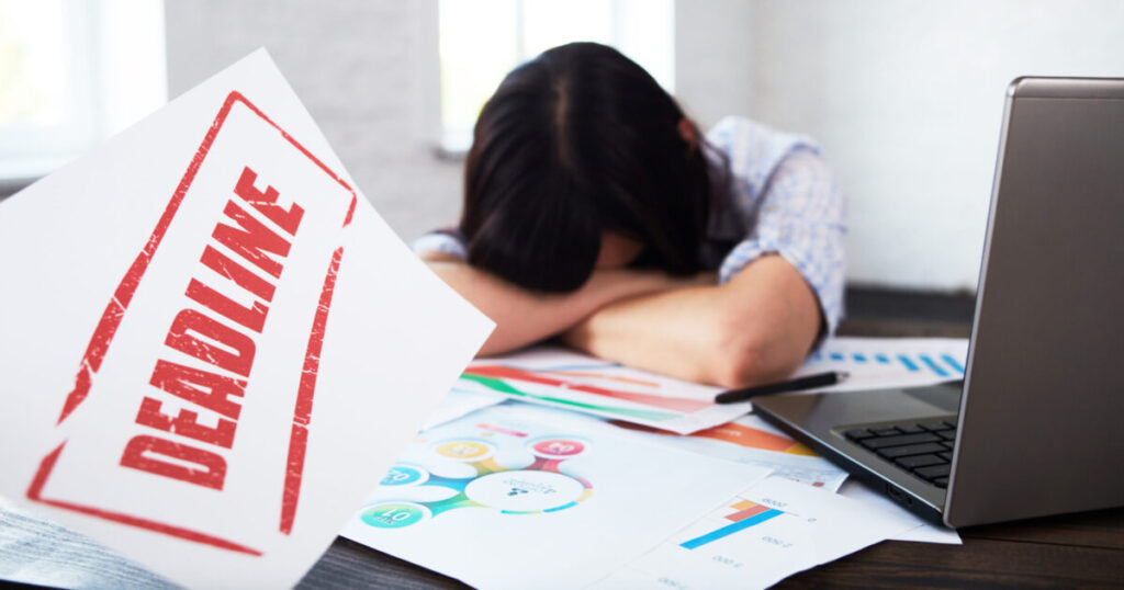 Avoid Penalties: Employer’s Ultimate Guide to Tax Filing Dates in Malaysia 3 tired disturbed female worker with headache stressed woman office holding head hands thinking about deadline scaled e1788940564281
