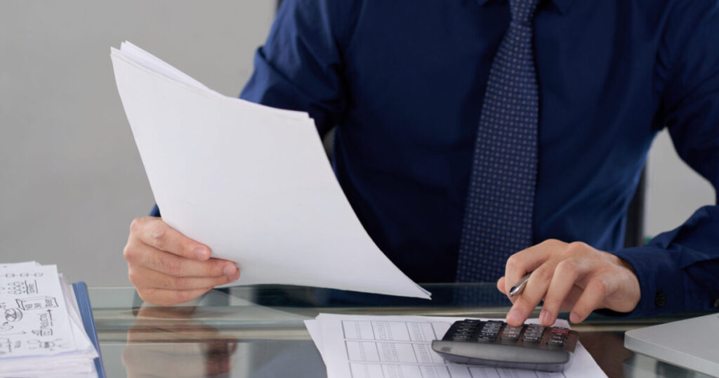 mid section anonymous male accountant calculating financial data scaled e1788927414585